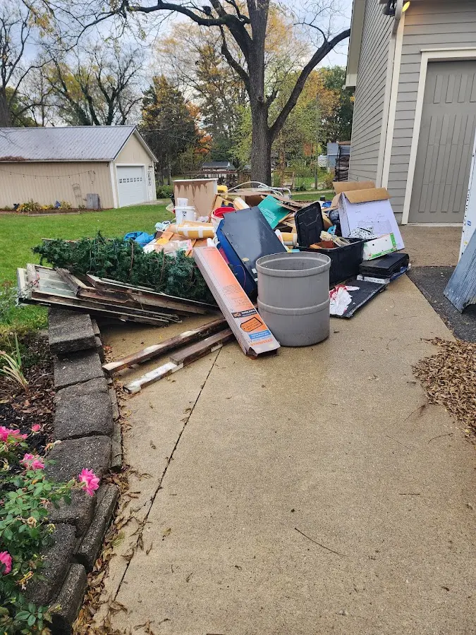 Dumpster being loaded with debris for Roofing Dumpster Rental in Grove
